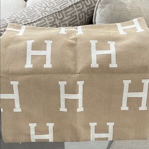 Tan cushion cover with White H Pattern